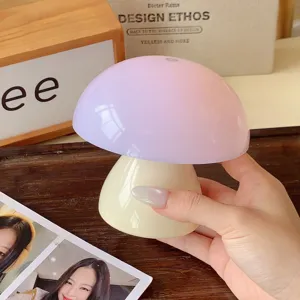 Close-up detail of the cute mushroom night light featuring soft pink and cream finish on desk.