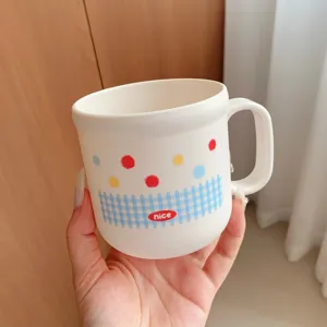 Cute ceramic mug with colorful polka dots and plaid pattern, ergonomic handle for daily use.