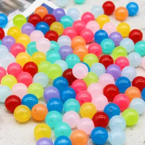 Colorful acrylic beads with holes for DIY jewelry making, ideal for children's handmade crafts.