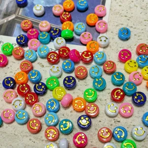Close-up detail of colorful acrylic smiley face beads, perfect for DIY jewelry and phone chains.