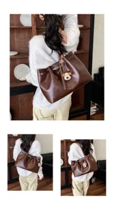 Detailed view of women's vintage brown tote shoulder bag with cute puppy plush pendant charm.