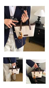 Vintage suede bucket bag with contrast trim and wooden bead pendant for women daily use.