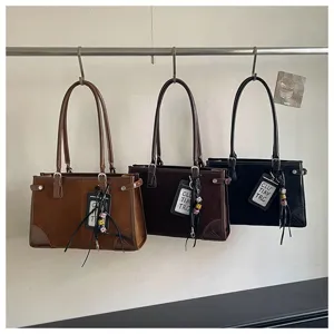 Detail shot of vintage women tote shoulder bags in multiple colors hanging on rack.