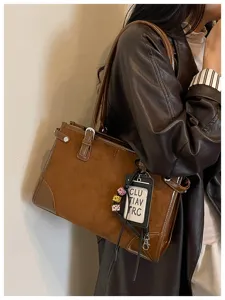Detailed view of vintage brown suede patchwork tote bag shoulder handbag with chic charm.