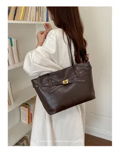Minimalist retro brown leather tote bag with metal turn lock, stylish large commuter shoulder bag.