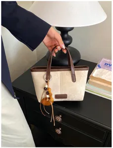 Vintage suede bucket bag for women, chic small handbag with wooden beads pendant and top handle.
