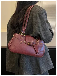 Retro dark red underarm shoulder bag detail showing stylish design and gold hardware.
