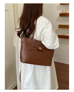 Retro brown PU leather tote bag with elegant belt buckle detail for women commuting daily.