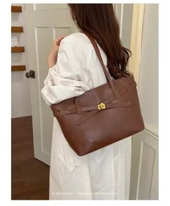 Brown retro leather shoulder tote bag detail view, minimalist commuter bag with metal lock.