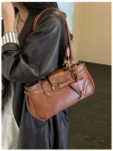 Detailed view of the vintage brown underarm bag showcasing premium leather texture and hardware.