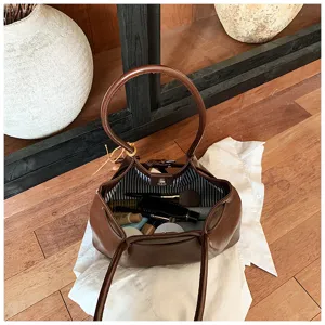 Brown retro leather hobo shoulder bag detail showing interior lining and cosmetic storage capacity.