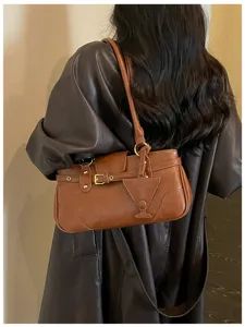 Retro brown faux leather shoulder bag for women, chic vintage baguette bag with metal buckle.
