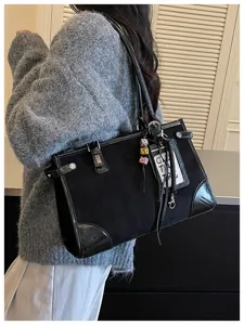 Casual black shoulder tote bag with vintage design, spacious interior for daily commute.