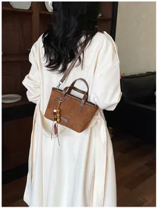 Vintage brown suede crossbody bag for women, chic retro shoulder bag with tassel pendant.