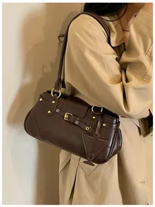Stylish brown vintage underarm bag for women, trendy baguette shoulder handbag with chic metal buckles.
