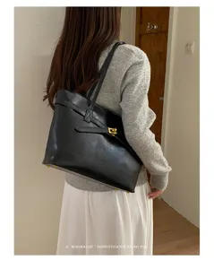 Minimalist black shoulder tote bag with metal lock, versatile retro commuter fashion accessory.