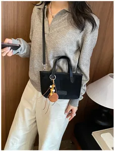 Retro black suede women shoulder bag, chic casual crossbody tote with beaded charm detail.
