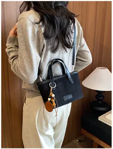 Retro suede bucket bag women's casual crossbody bag with shoulder strap and chic charms.