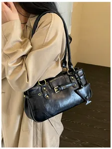 Detail view of a trendy black retro underarm shoulder bag with chic gold hardware accents.