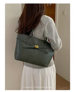 Minimalist retro dark green shoulder tote bag with elegant gold turn-lock detail for commute.