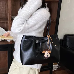 Black PU leather tote bag for women, casual large capacity shoulder bag with cute dog pendant.