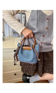 Stylish denim bucket handbag for women, trendy casual shoulder crossbody bag with brown handle details.