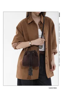 Retro suede bucket bag for women, stylish tassel drawstring shoulder and crossbody handbag.