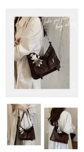 Detailed view of the stylish glossy leather messenger bag showcasing textured finish and cute pendant.