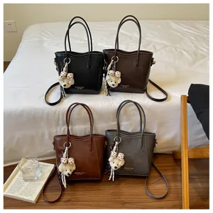 Elegante borsa a secchiello in pelle PU da donna con ciondolo a orsetto per uso quotidiano.