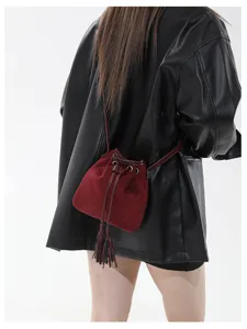 Chic retro matte suede shoulder bucket bag with tassel drawstring for women autumn winter style.