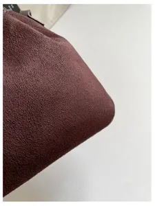 Brown suede bucket bag detail showcase, vintage retro style autumn winter fashion accessory.