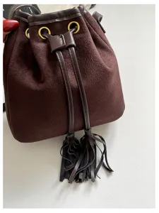 Brown suede bucket bag for women, retro drawstring shoulder bag with chic tassels.