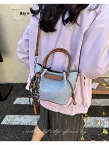 Stylish casual women shoulder bag vintage bucket bag with top handle and chic charm decor.