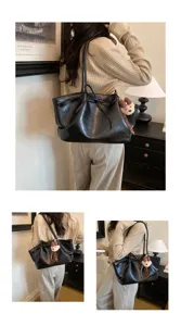 Detailed view of the vintage black PU leather tote bag with stylish bow and cute bear pendant.