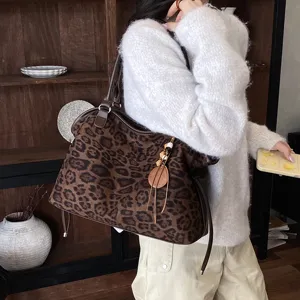 Vintage suede leopard print tote bag with shoulder strap and chic wooden bead tassel charm.