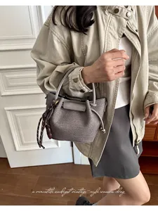 Women vintage style pleated bucket bag versatile handbag with shoulder strap for daily wear.
