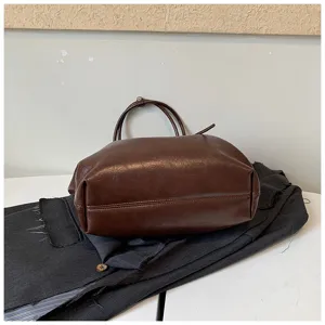 Dark brown vintage large capacity tote bag detail view, casual commuting shoulder bag.
