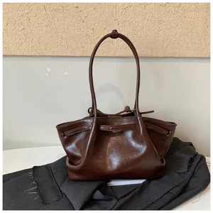 Detailed view of the dark brown retro leather tote bag, showcasing texture and handle craft.
