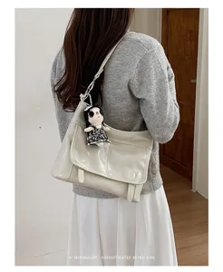Retro women messenger bag with plush doll pendant, stylish shoulder crossbody design for daily wear.