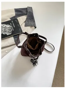 Retro suede bucket bag for women, stylish autumn winter shoulder and crossbody bag with tassel.