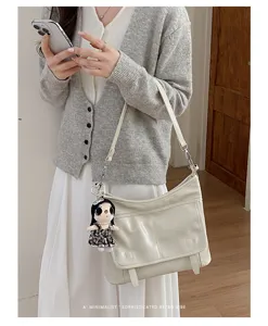 Minimalist retro leather messenger bag stylish women shoulder crossbody bag detail view.