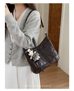 Stylish retro messenger shoulder bag detail showcasing premium PU leather texture and chic style.