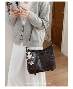 Chic retro brown PU leather messenger bag for women, versatile shoulder crossbody bag detail.