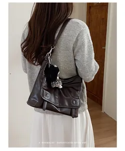 Retro brown women messenger shoulder bag detail shot, vintage style daily chic accessory.