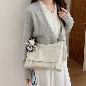 Chic fashion women messenger shoulder bag, trendy retro crossbody bag with cute doll pendant.