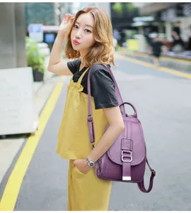 Details of a stylish purple soft leather women backpack showing texture and strap design.