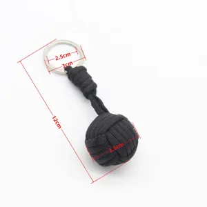Black paracord monkey fist keychain detail showing length and ball diameter measurements.