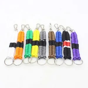 Hand-woven paracord keychain detail showing multiple colorful outdoor keyring variants.