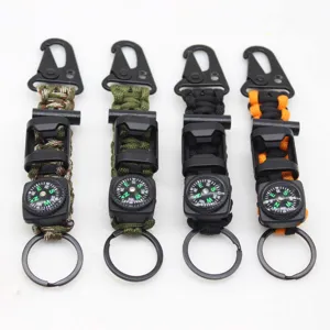 Close-up detail of multi-functional outdoor survival paracord keychain with compass and hook.