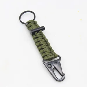 Detailed view of military green survival paracord keychain with metal carabiner and flint.